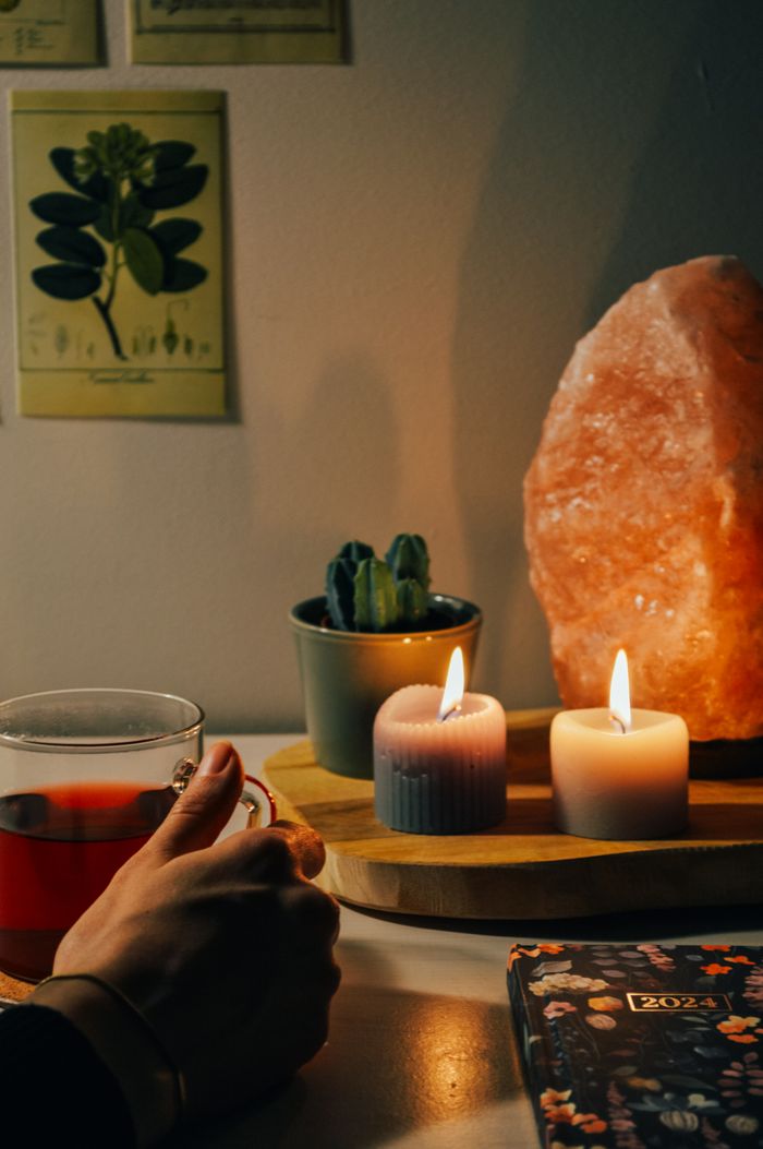The Art of Drawing Readers In: Your attractive post title goes here A warm, cozy setting featuring candles, a cup of tea, and cacti decor for a relaxing ambiance.